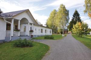 a white house with a gravel driveway at Valamon Luostari in Uusi-Valamo
