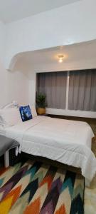 a bedroom with a large bed with a colorful rug at Mul House Syariah in Bedakah