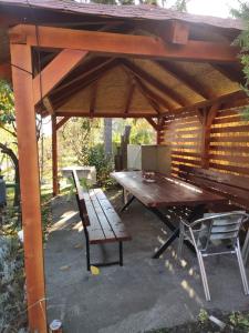a picnic table and a bench under a pavilion at Apartment Ljupka in Pančevo +14 photos