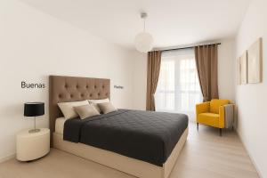 a bedroom with a bed and a yellow chair at Fairytale in Adeje in Adeje