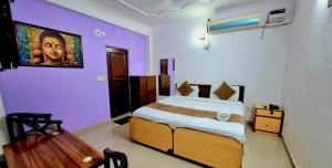 a bedroom with a large bed with purple walls at Atlas Inn Stay Near IGI Airport T3 in New Delhi