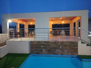 a villa with a swimming pool and a house at Kliprivier Accommodation in Johannesburg +56 photos