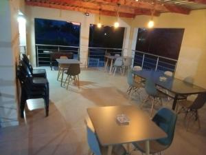 a dining room with tables and chairs and windows at Kliprivier Accommodation in Johannesburg
