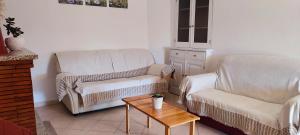 a living room with a couch and a chair and a table at Tana di Zia Nature, Yourself, Love in Viggianello +62 photos