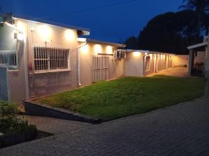 a house with lights on the side of it at Kliprivier Accommodation in Johannesburg