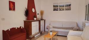 a living room with a couch and a chair at Tana di Zia Nature, Yourself, Love in Viggianello