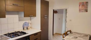 a kitchen with a stove top oven next to a table at Tana di Zia Nature, Yourself, Love in Viggianello +61 photos
