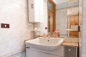 a bathroom with a white sink and a mirror at Casa Vacanza Le More in Cares +18 photos