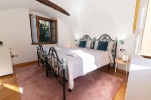 a bedroom with a large bed with blue pillows at Casa Vacanza Le More in Cares