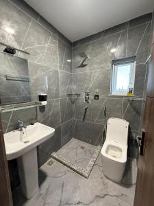 a bathroom with a toilet and a sink at Bliss View Apartments Nepal in Pātan +3 photos