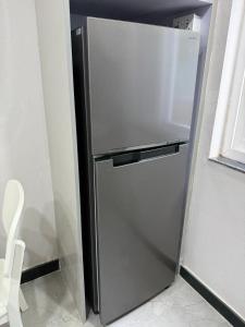 a stainless steel refrigerator in a kitchen next to a window at Bliss View Apartments Nepal in Pātan