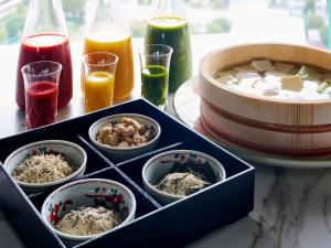 a table topped with bowls of food and drinks at Nagoya Kanko Hotel in Nagoya