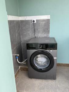 a washing machine in the corner of a room at Bliss View Apartments Nepal in Pātan