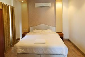 a bedroom with a bed with two towels on it at Muscat-Seeb 1BHK comfort apartment in Seeb