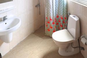 a bathroom with a toilet and a sink at Muscat-Seeb 1BHK comfort apartment in Seeb
