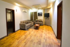 a living room with two couches and a table at Muscat-Seeb 1BHK comfort apartment in Seeb