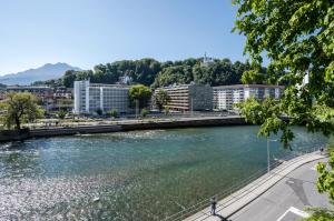 een rivier in een stad met gebouwen en een brug bij Boutique Hotel KARL in Luzern