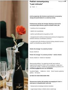 a page of a wine bottle on a table with a flower at Art Apartments Warszawska 21 Katowice in Katowice +44 photos