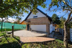 a house with a large garage in front of it at Non stop apartman in Kaposvár +14 photos