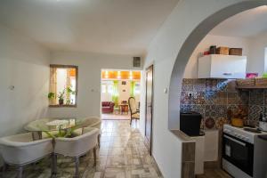 a kitchen and living room with a table and chairs at Non stop apartman in Kaposvár