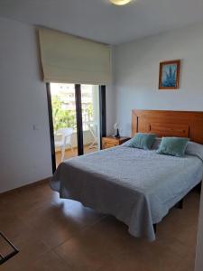 a bedroom with a large bed and a large window at Apartamentos Plaza in Nerja