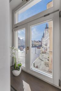 a window with a view of a city at Stylový byt v srdci Hradce Králové in Hradec Králové