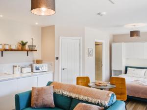 a living room with a couch and a bed at Elm - Uk50463 in Alvington