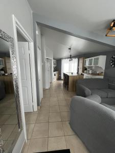 a living room with a couch and a table at Charmant Petit Condo Ski in Val-Brillant