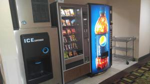 a drink vending machine next to a drink cooler at Americas Best Value Inn Saint Robert/Fort Leonard Wood in Saint Robert