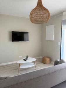 a living room with a couch and a table at Hotel Aquarius in Canet-en-Roussillon