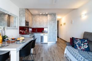 a kitchen and living room with a table and a couch at Calahonda Beach Apartments in Sitio de Calahonda