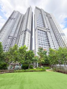 two tall buildings with a park in front of them at Agile bukit bintang trx by klcc sky view in Kuala Lumpur