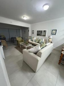 a living room with a white couch and a table at Keurbooms River in Keurboomstrand