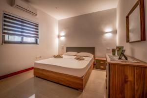 a bedroom with a large bed and a window at Modern SeaView Luxury Apartment in St. Paul's Bay