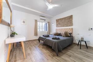a bedroom with a large bed and a table at Beach Side Apartments Calahonda in Sitio de Calahonda