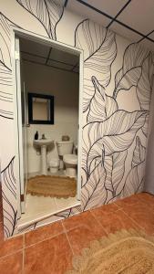 a bathroom with a mural of a bathroom with a toilet at Entire 6 Bedroom Retreat With Pool - 16 guests in Jayuya