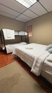 a bedroom with two bunk beds and a window at Entire 6 Bedroom Retreat With Pool - 16 guests in Jayuya