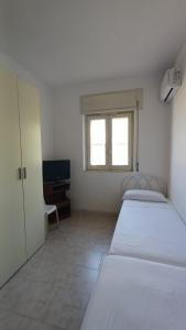 Ένα ή περισσότερα κρεβάτια σε δωμάτιο στο Casa Vacanze Il Giglio di Mare