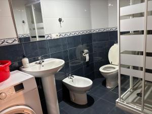 a bathroom with a sink and a toilet at Casa Criseva II in Avín +5 photos