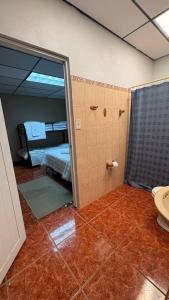 a bathroom with a mirror and a room with a bed at Main House 3BR, 3 Bath, Pool - 8 people in Jayuya +46 photos