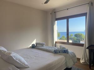 a bedroom with a bed and a large window at La Isla in Sa-Riera +27 photos