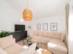 een woonkamer met een bank en een tv bij Villa Mima Pool Retreat in Opanci