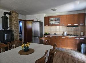 a kitchen with a table and chairs and a refrigerator at Holiday Home Green Oasis Lika in Lovinac