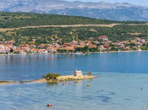 a small island in the middle of a body of water at Holiday Home Green Oasis Lika in Lovinac
