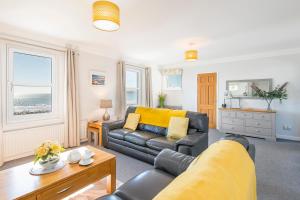 a living room with a couch and a table at Pebble Reach in Amroth