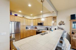 a large kitchen with wooden cabinets and a counter top at Ocean Lover's Landing in Gold Beach