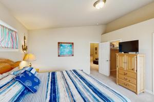 a bedroom with a bed and a flat screen tv at Ocean Lover's Landing in Gold Beach