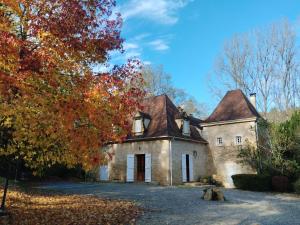 an old stone house in the fall at Le Manoir de la Feuillade in Carsac-Aillac