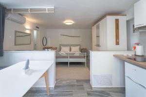 a kitchen and living room with a bed in the background at WHITE W4 new studio in Naousa in Naousa