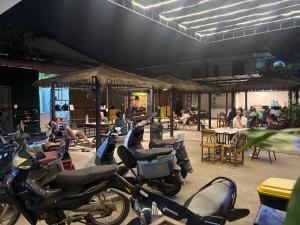 a group of motorcycles parked in a parking lot at Venn Hostel in Vientiane